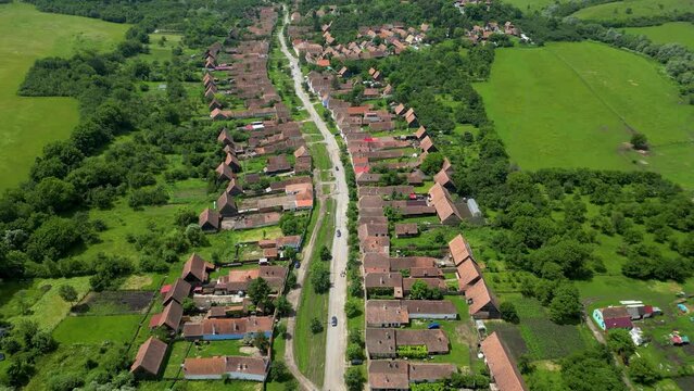 Aerial view of famous and traditional Village Viscri. Situated in Romania, Brasov this village become a famous travel destination after of England bought a vacation home here. Drone forward