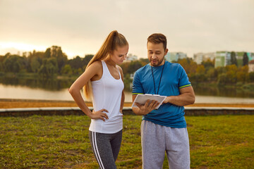 Professional sports coach offers individual training program to young female athlete. Beautiful...