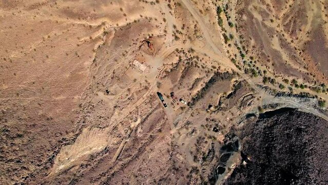 Aerial Top Shot Of People And Off-Road Vehicles In Desert Area, Drone Flying Downwards On Sunny Day - Landers, California
