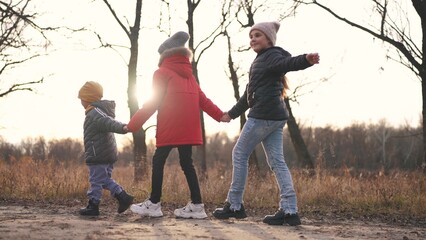 children walk in the forest in autumn park. happy family kid dream concept. a group of children...