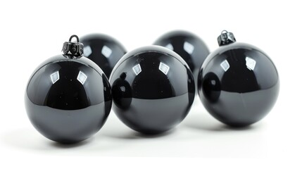 A group of black Christmas ornaments displayed on a white surface. Perfect for adding a touch of elegance to your holiday decorations