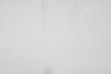 Cement white wall with a large crack copy space for text. Grunge concrete cement white wall with a...