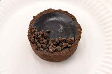 Round chocolate cookie on grey background closeup