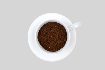 A cup of ground coffee isolated on a gray background. top view.