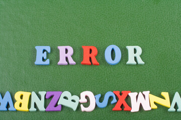 ERROR word on green background composed from colorful abc alphabet block wooden letters, copy space for ad text. Learning english concept.
