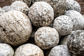 Pile of Ancient Stone Cannonballs from Historical Era