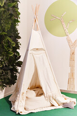 Indian tent, teepee in kids game room. © Kryuchka Yaroslav