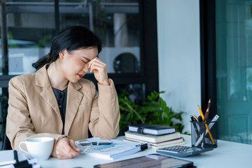 Businesswoman is thinking and is stressed about work.