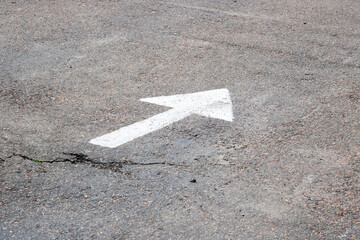 A white arrow is drawn on the asphalt