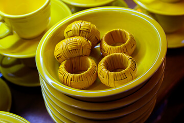 A set of old Yellow ceramic bowls, cups, saucers, and napkin rings are for sale at this Antique...
