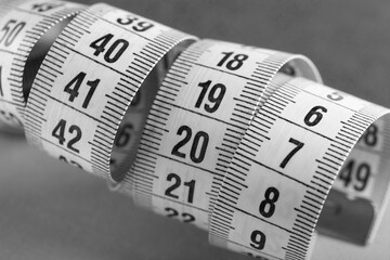 sewing tape measure for taking measurements on a black and white background