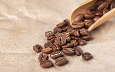 freshly roasted coffee beans and wooden spoon