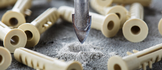 metal drill bit make holes in concrete wall on industrial drilling