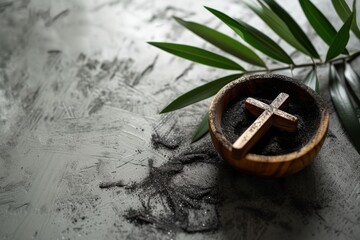 Obraz premium Ash Wednesday,faith, liturgy, religious ceremony background. Wooden cross, ceremonial dish with ash and palm leaf branch on gray background. Top view