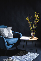 interior, holidays and home decor concept - modern blue chair with pillow and easter eggs in vase...