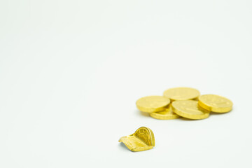 Stack of chocolate coins isolated on white background copy space, group of golden chocolate coins money