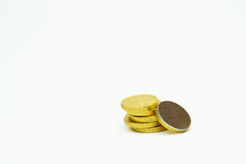 Pile of gold chocolate coins isolated on white background, stack of coins, heap of chocolate money coins