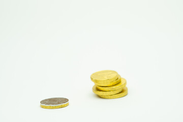 Pile of gold chocolate coins isolated on white background, stack of coins, heap of chocolate money coins