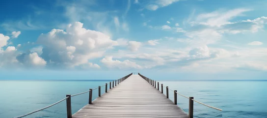 Fototapeten Wooden pier with blue sea and sky background  © Koray