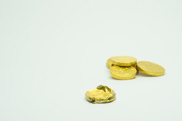 Stack of chocolate coins isolated on white background copy space, group of golden chocolate coins money