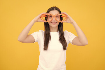 Portrait of a funny girl wearing cool party glasses. Cheerful young girl smiling with heart-shape...