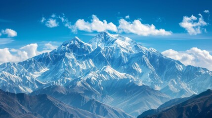 Obraz premium A majestic mountain range, with snow-capped peaks towering against a backdrop of clear blue skies