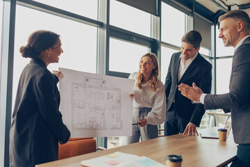 Team of business investors is discussing a new project in modern office. Concept of financing