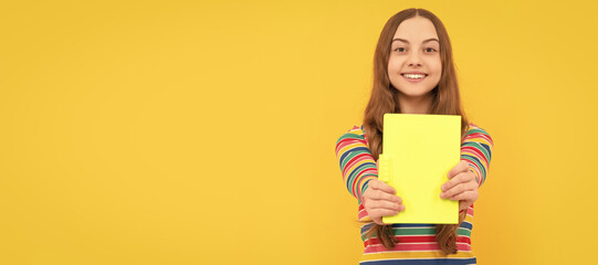 Happy kid smile showing school book for copy space yellow background, knowledge. Banner of school girl student. Schoolgirl pupil portrait with copy space.