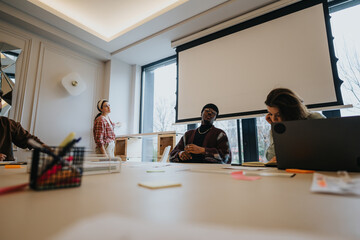 Fototapeta premium Mixed race, business coworkers in a business meeting with discussion in modern office space.