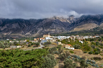 Fototapeta na wymiar Psiloritis mountain with low cloud coverage and the traditional village of Fourfouras, in central Crete island, very close to Rethymno town, in Greece
