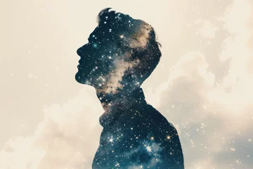  double exposure image of a man's silhouette filled with a starry night sky. © Formoney