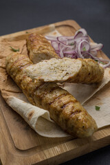 Delicious Lyulya kebab on a wooden board. Close-up 