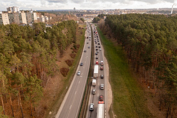 Drone photography of a traffic jam in the middle of the day during autumn .