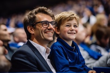 Enthusiastic french father and son in stands supporting national rugby/football team in blue attire - obrazy, fototapety, plakaty