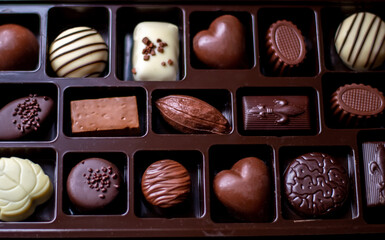 Still life of chocolate choices in milk, dark and white chocolate. A delicious background