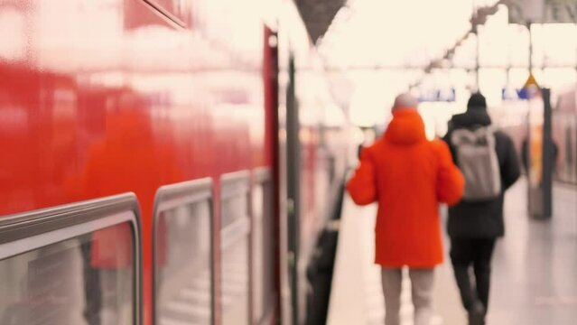 passengers late, running to German railway train, platform Frankfurt am Main station, out of focus video, people with luggage and backpack boarding travelers in cars, Frankfurt - January 31, 2024