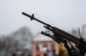 A close-up of the barrel of the m-16 machine gun on a blurred background