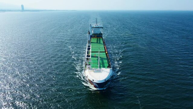 Aerial front view of Bulk cargo carrier ship for carrying dry cargo cruising across the sea