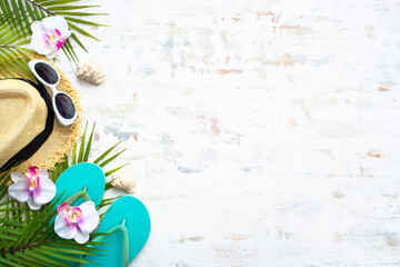 Summer cloth and accessories. Palm leaves, hat, flip flop and sunglasses on white background. Flat...
