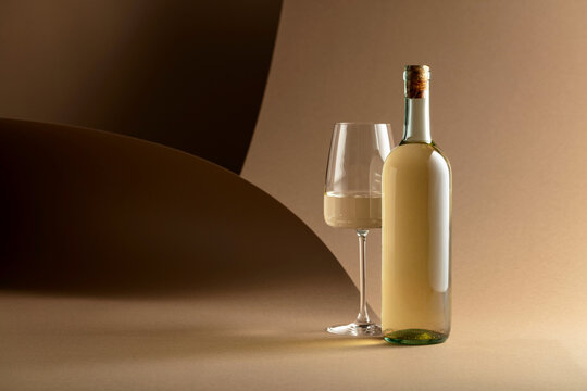 Bottle and glass of white wine.