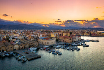 Chania with the amazing lighthouse, mosque, venetian shipyards, at sunset, Crete, Greece. - 733429078