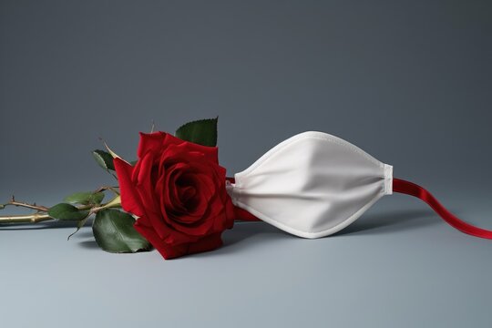 Red Rose Lying With Medical Mask, Copy Space. Valentines Day And Covid-19 Concept Romance. New Normal Valentine's Day, COVID Protection. Hygiene Pandemic Concept. Women's Day, Wedding And Love Concept