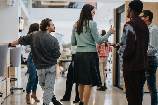 Business group of creative people networking in a modern office setting, showcasing casual business interactions and teamwork dynamics.