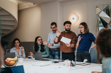 Dynamic business team engaged in a collaborative discussion in a modern office.