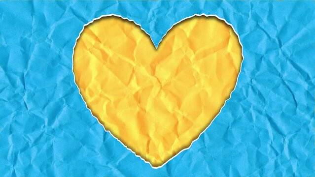 Scrap of paper in the shape of a heart in the colors of the Ukrainian flag