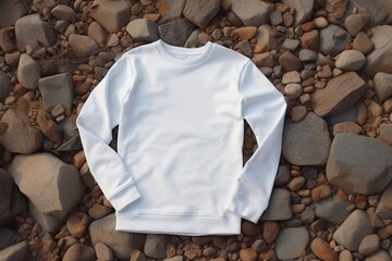 White mockup sweatshirt lay on rocks on beach of sea or river - 733435487