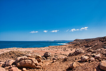 Low coastal cliff landscape with boulders from the Cretaceous Period along the Mushroom Rock Trail, Kalbarri National Park, Western Australia
