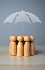 A group of people and an umbrella above. The concept of insurance and social protection. Life...
