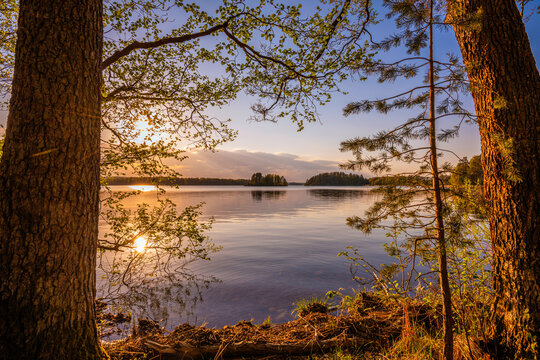Framed lake by trees sunset © Christian