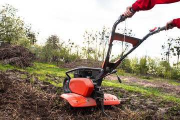 Cutting-edge agricultural technology at play: the tiller meticulously tills the untouched soil,...